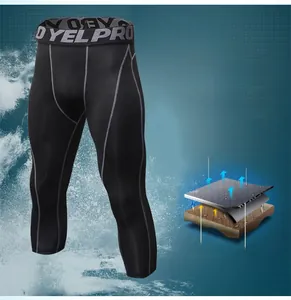 Close-up of quick-dry men's compression pants showing reinforced grey stitching and elastic waistband