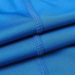 Close-up of breathable mesh fabric and flatlock stitching on blue sports long sleeve top