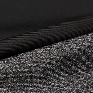 Macro detail of black ribbed fabric stitched with grey heather knit sport material