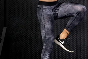 Detail view of men's grey snake skin compression leggings with 3D cut and elastic waistband