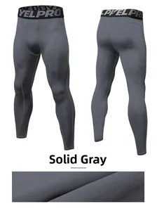 Detail of grey men's compression pants showing elastic waistband and breathable fabric