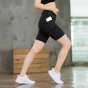 Women's high waist yoga shorts with side pockets in black stretch compression fabric
