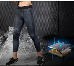 Detail of men's athletic compression pants showing grey geometric texture and moisture-wicking