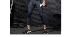 Detailed view of men's compression tights with grey honeycomb texture and slim fit design