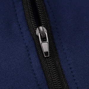 Detailed close-up of a durable black metal zipper on a dark blue athletic sweatshirt