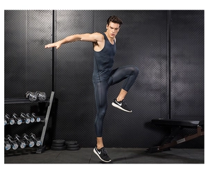 Detail of men's dark grey 3D printed compression tank top and 3/4 leggings gym set