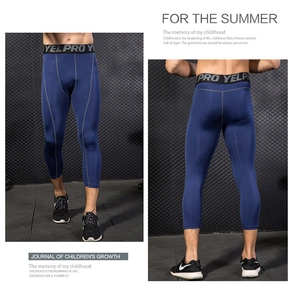 Detail view of men's PRO compression capri pants with flatlock stitching and logo