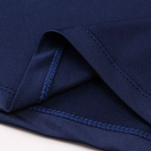 Detail of navy blue stretch fabric showing double-stitched hem and smooth knit texture