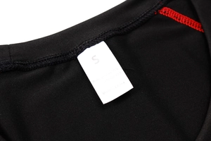 Detailed view of the neck label showing size S and 85% polyester material composition