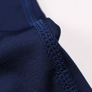 Macro shot of flatlock stitching and breathable texture on dark blue sports fabric