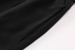 Detail view of pocket stitching on black athletic shorts with breathable fabric