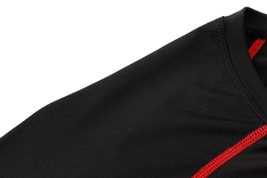 Detail of black athletic compression shirt showing red reinforced flatlock stitching