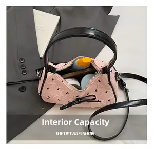 Internal capacity of pink bow handbag showing phone and cosmetics in organized detail