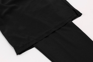 Detail view of the side slit design and stitching on men's black athletic leggings