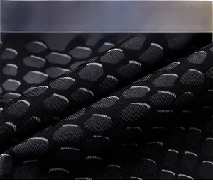 Detailed view of breathable snake scale patterned fabric for men's athletic compression pants