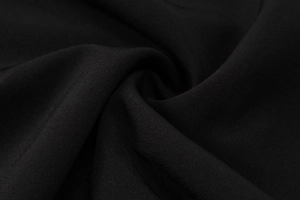 Close-up of black breathable athletic fabric showing soft texture and premium weave pattern