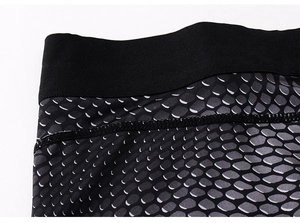 Macro shot of men's compression pants featuring honeycomb pattern and elastic waistband