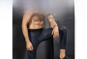 Detail view of men's Pro compression pants featuring honeycomb textured 3D fabric pattern