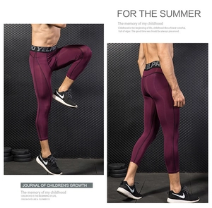 Detailed side view of wine red compression sports leggings with elastic waistband