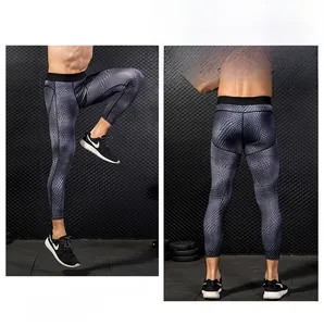 Detail view of men's compression pants with dark grey scale pattern for pro fitness sports