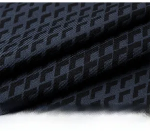 Macro detail of breathable navy compression fabric with geometric 3D pattern for men's sports vest