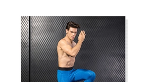 Detail of blue men's athletic compression pants with honeycomb texture and elastic waistband
