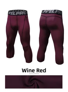 Detail of wine red pro compression pants with ergonomic seams and stretch fabric texture
