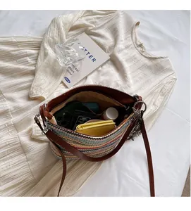 Interior view of striped woven bag showing spacious capacity for phone and wallet