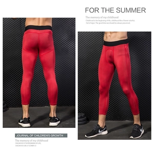 Detail of red compression pants showing honeycomb mesh texture and black elastic waistband