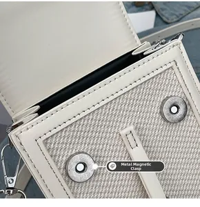 Detail of canvas and leather patchwork bag with silver magnetic snap button closure