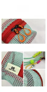 Detail of mint green mesh pouch with colorful braided lanyard and dual zippers