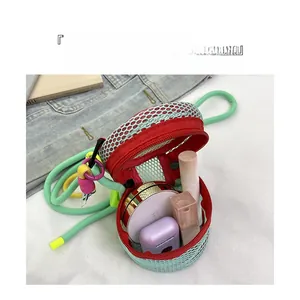 Mini mesh crossbody bag interior showing storage space for lipstick and earphones