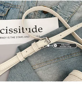 Detail of adjustable white PU leather strap with silver metal buckle on a shoulder bag