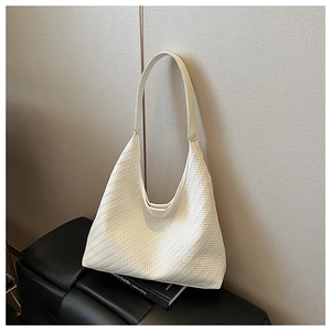 Detail of white woven PU leather hobo bag with unique V-pattern texture and large capacity