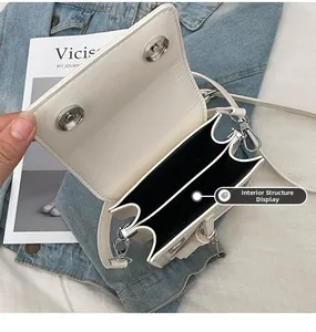 Detailed interior of the white PU leather crossbody bag featuring dual compartments and magnetic buckle