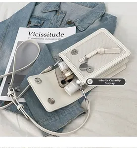 Internal view of small white crossbody phone bag showing space for phone and makeup