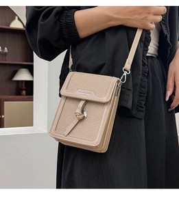 Close-up of beige woven texture and leather contrast on crossbody phone bag