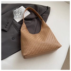 Close-up of woven leather hobo bag in brown finish with wide shoulder strap