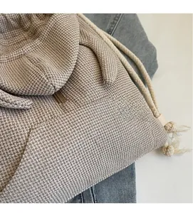 Detail of waffle knit fabric hoodie with rabbit ears decoration and thick drawstrings