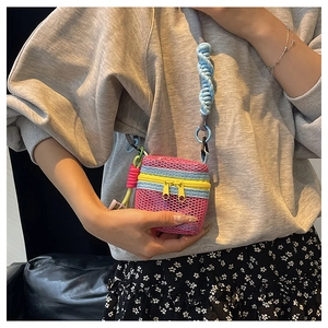 Mini magenta mesh crossbody bag with neon yellow zippers and blue rope strap detail
