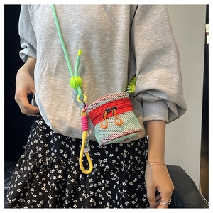 Detail of mini mesh crossbody bag with neon rope strap and colorful zipper accents