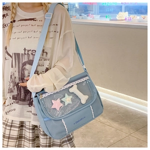 Close-up of light blue crossbody bag with lace trim and transparent star-filled pocket