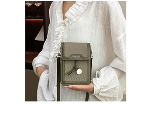 Detail of olive green lychee leather mobile phone bag with knotted pendant and silver tag