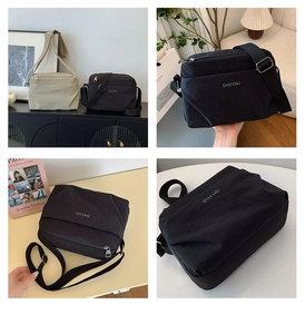 Detail of minimalist nylon crossbody bag featuring the logo and front zipper compartment