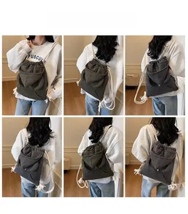 Detail view of charcoal grey knit drawstring bucket bag with cute animal ear hood design