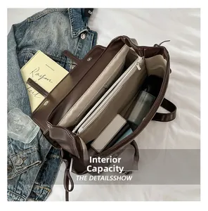 Internal capacity view of a large coffee brown faux leather tote with multi-compartments