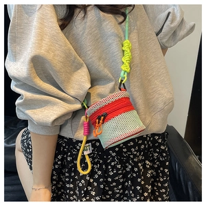 Detailed shot of a colorful woven shoulder strap with bright green mesh and red zipper