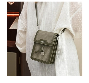 Green leather crossbody phone bag with woven texture and decorative tassel details