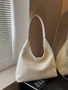 Chic off-white woven hobo bag with wide strap and spacious retro bucket style design
