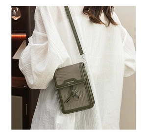 Olive green leather crossbody bag with woven texture detail and slim shoulder strap